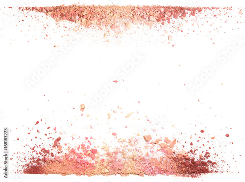 Samples of dry blush, powder, bronzers and highlighter scattered in a line isolated on a white background
