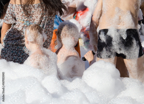 Youth at a foamy party on the beach