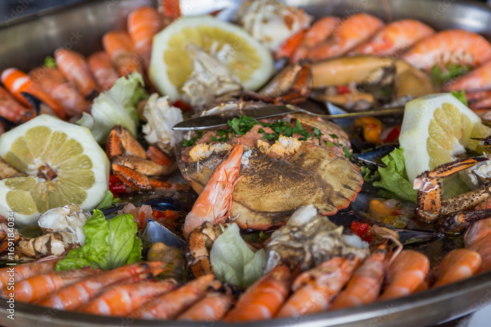 serving plate seafood and crab in big metal dish serving plate seafood and crab in big metal dish