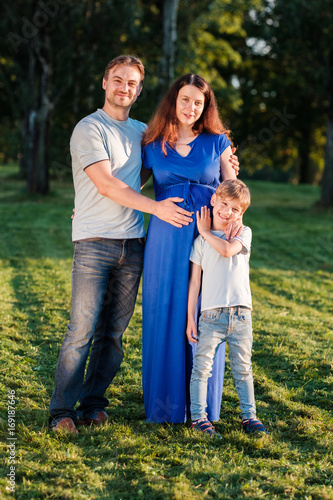 Happy pregnant family of three expecting new baby