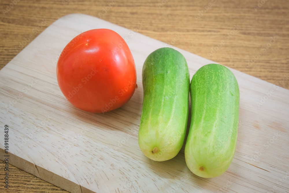 Fresh Tomato with Cucumbers on Cutting Board Fresh Tomato with Cucumbers on Cutting Board