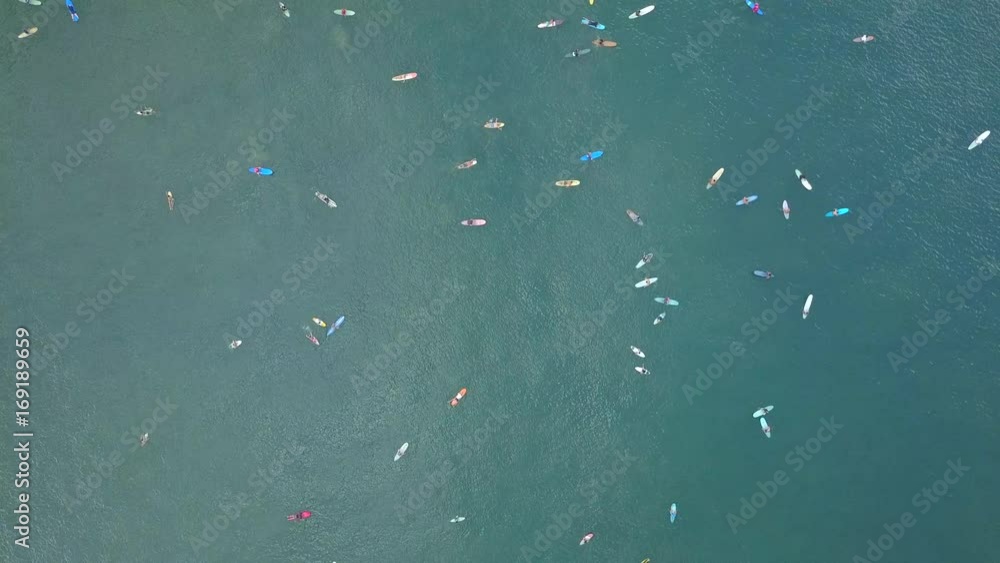 AERIAL: Crowd of surfers & longboarders waiting in lineup to catch breaking wave in popular surfspot in Bali. Crowds of people surfing on Canggu beach. Beginner surfboarders learning how to ride swell AERIAL: Crowd of surfers & longboarders waiting in lineup to catch breaking wave in popular surfspot in Bali. Crowds of people surfing on Canggu beach. Beginner surfboarders learning how to ride swell