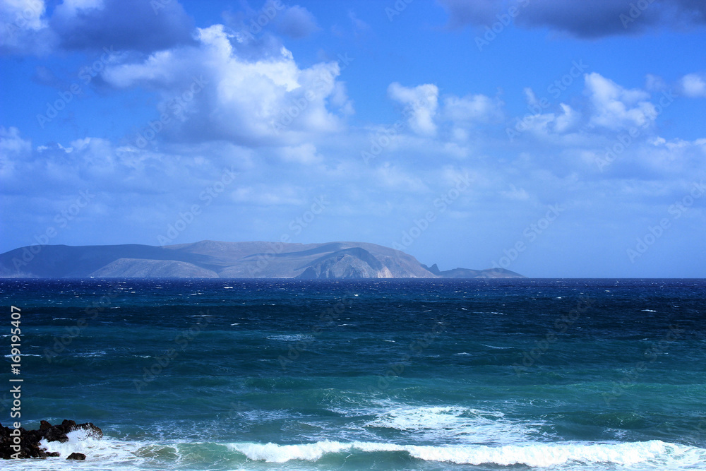Beautiful scenery of the sea and mountains with white clouds in the summer