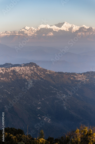 Kangchenjunga mountain in the morning with blue and orange sky and mountain villages that view from The Tiger Hill in winter at Tiger Hill, Darjeeling. India.