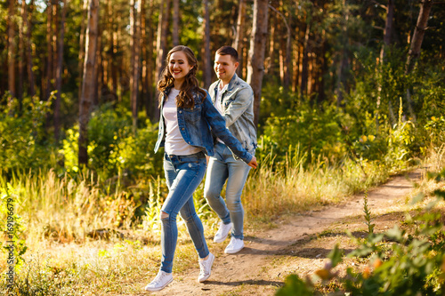 Fototapeta Naklejka Na Ścianę i Meble -  Young couple running at the nature.Summer day jogging.
