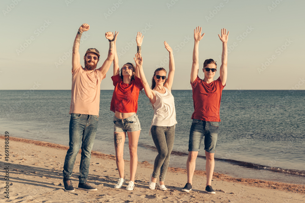 Obraz premium Group of young people enjoy summer party at the beach