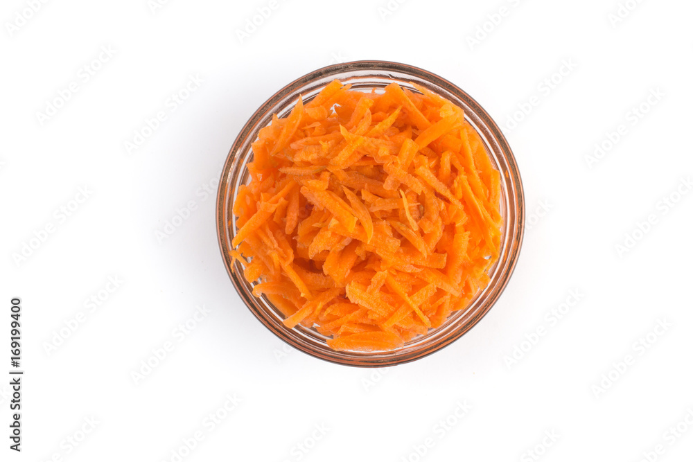 Grated Carrots into a glass bowl Grated Carrots into a glass bowl