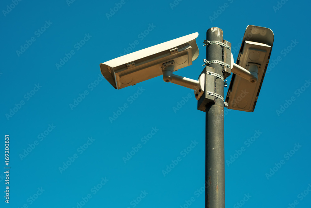 Two CCTV security cameras mounted on high post Two CCTV security cameras mounted on high post