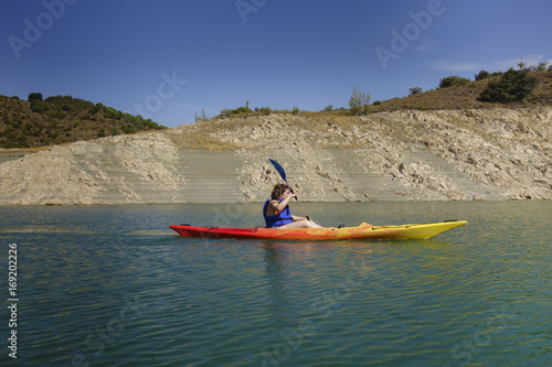 Young woman rowing in a kayak