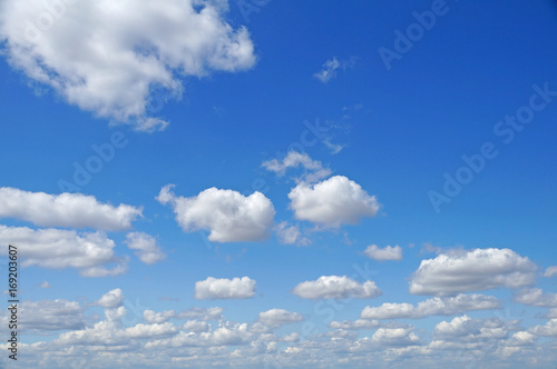 Fluffy white clouds on a blue sky.