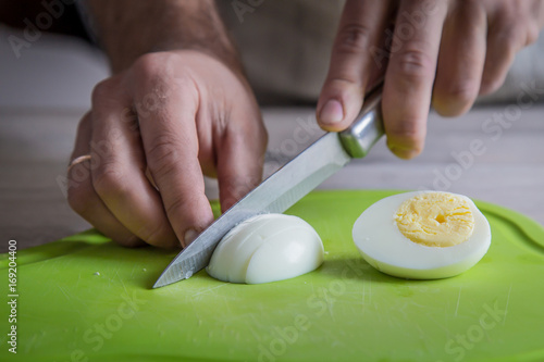 cutting eggs on green cutting board