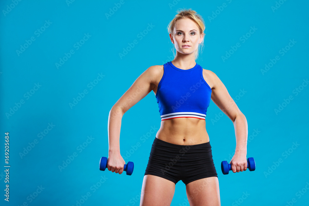 Fit woman lifting dumbbells weights Fit woman lifting dumbbells weights