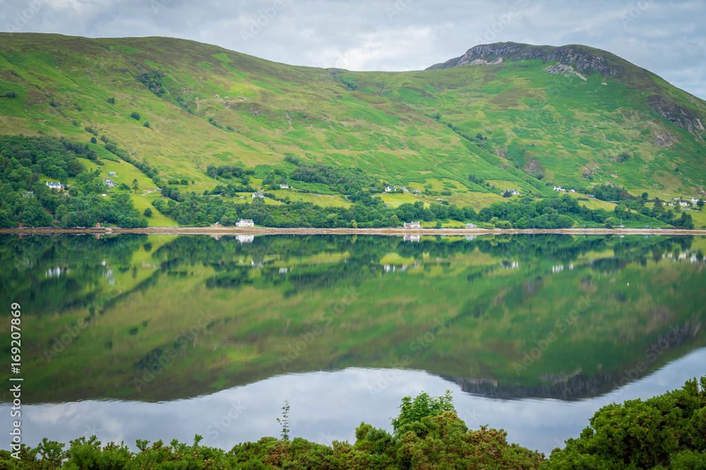 Mirror like reflections over Loch Broom in a cloudy morning