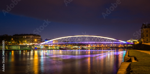Bernatka footbridge over Vistula river at night in Cracow, Poland