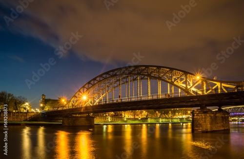 Bridge over Vistula river at night in Cracow, Poland