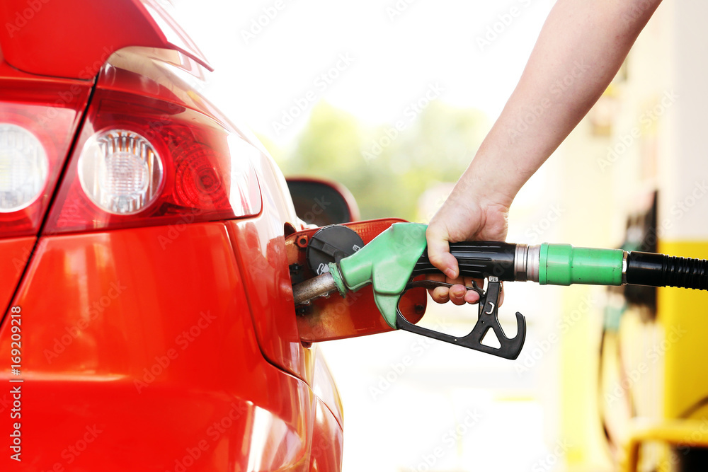 Refueling red car at the refuel station