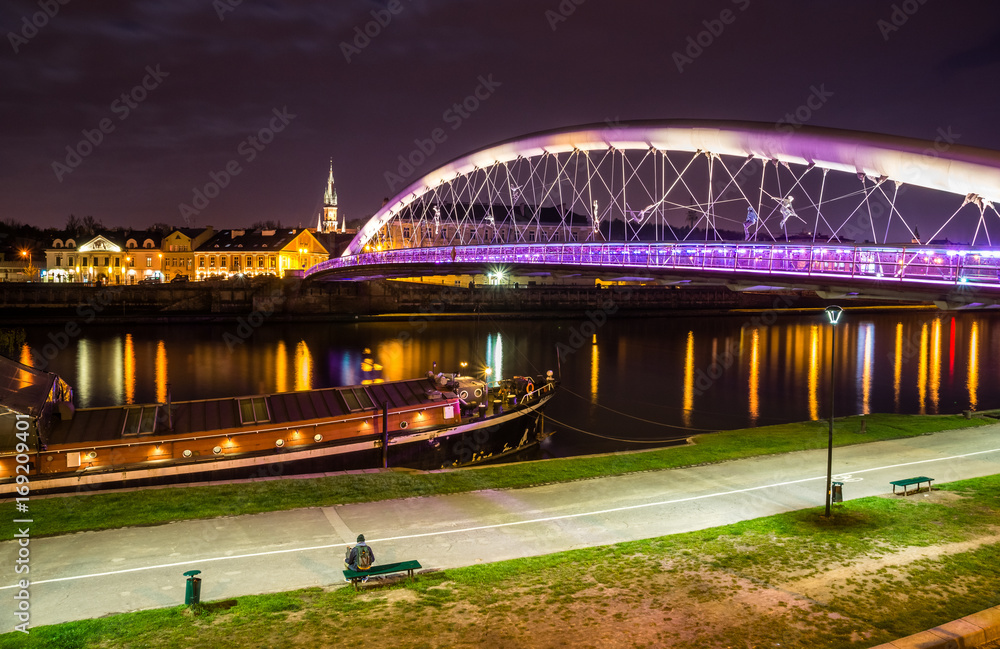 Fototapeta premium Bernatka footbridge over Vistula river at night in Cracow, Poland