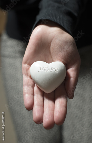 Woman hold in hands heart. Text hope