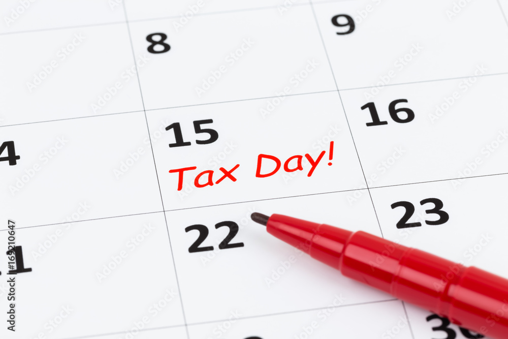Tax day on calendar with red marker pen Tax day on calendar with red marker pen