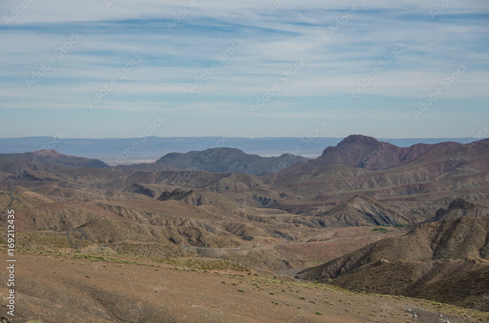 Panorama of High Atlas mountain range and serpentine road from on of pass, Morocco, Africa