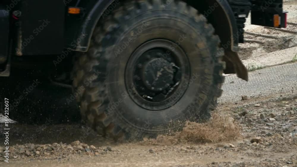 Slow motion shot of spinning wheels of a Russian military truck Slow motion shot of spinning wheels of a Russian military truck