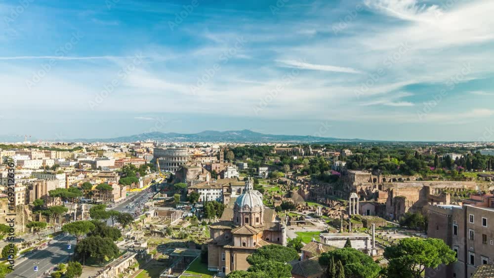 Aerial wide angle view timelapse of famous ancient Colosseum Amphitheater from Vittoriano at sunny day. Rome, Italy. April, 2016. Aerial wide angle view timelapse of famous ancient Colosseum Amphitheater from Vittoriano at sunny day. Rome, Italy. April, 2016.