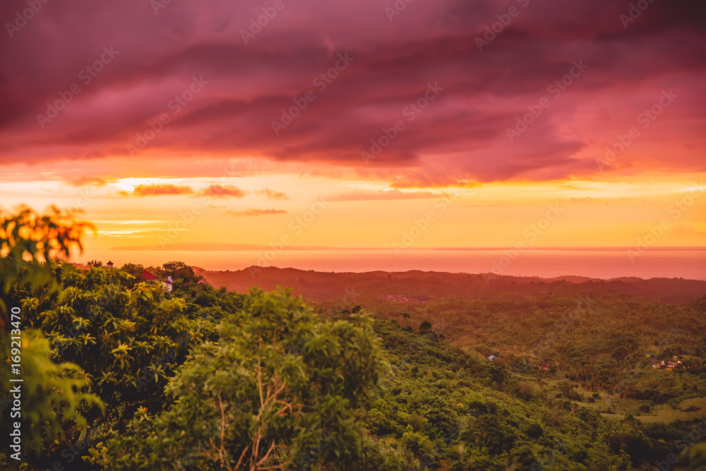 Sunset in tropical island, clouds and warm colors in Bali