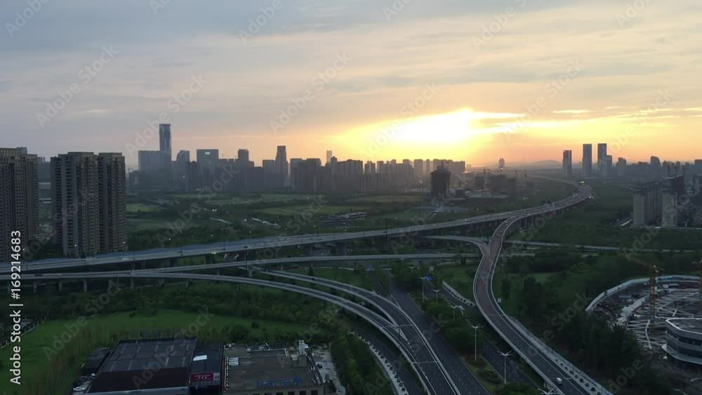 road junction and buildings in modern city at sunrise road junction and buildings in modern city at sunrise