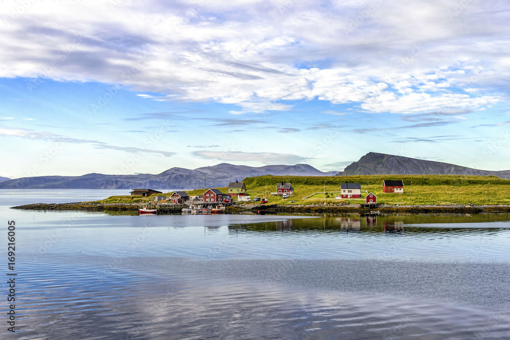 View of small fishing village in Mageroya island, Norway. Mageroya is a large island in Finnmark county, in the extreme northern part of Norway View of small fishing village in Mageroya island, Norway. Mageroya is a large island in Finnmark county, in the extreme northern part of Norway