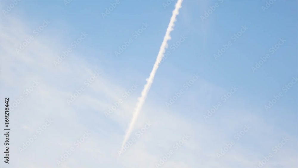 Jet airplane with trail against the blue sky. 4k video