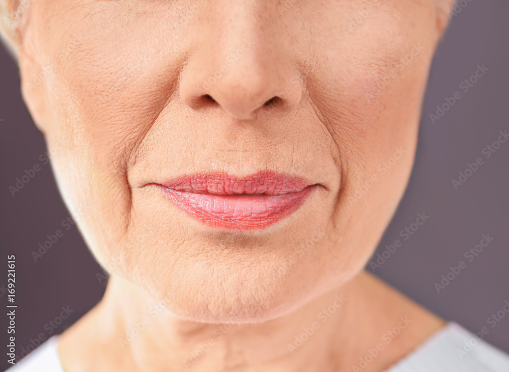 Fototapeta premium Closeup view of beautiful elderly woman on gray background