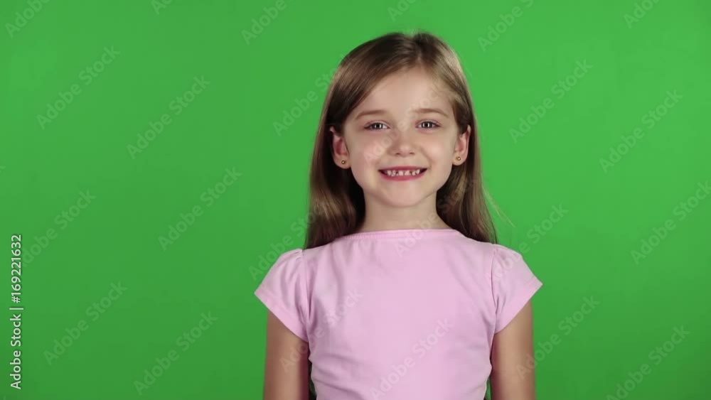 Child genuinely smile at the camera. Green screen. Slow motion Child genuinely smile at the camera. Green screen. Slow motion