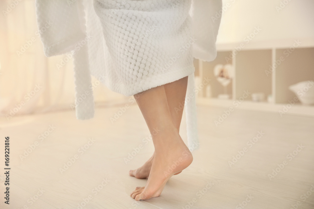 Young woman walking on floor after shower Young woman walking on floor after shower