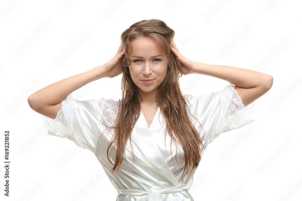Beautiful young woman in silk bathrobe after shower on white background Beautiful young woman in silk bathrobe after shower on white background