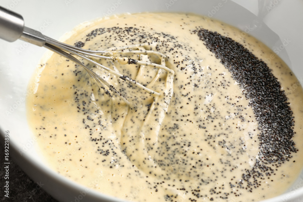 Raw dough with poppy seeds in bowl, closeup Raw dough with poppy seeds in bowl, closeup