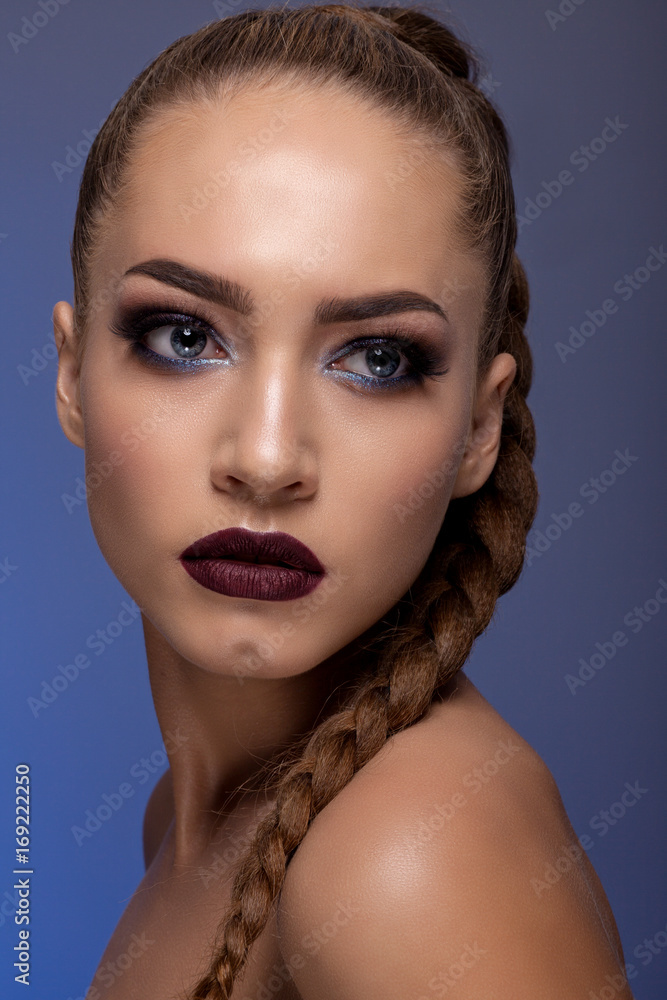 Creative portrait of a teenage girl on a blue background Creative portrait of a teenage girl on a blue background