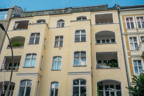 yellow building with big balconies