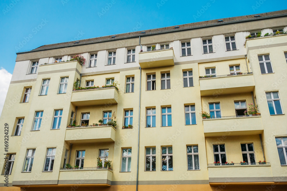 yellow building with white roof and blue sky yellow building with white roof and blue sky