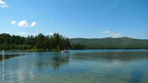 Boat transport on the river , ride down a beautiful tropical river , Group of happy people on Lake. Motorboat with Family photo