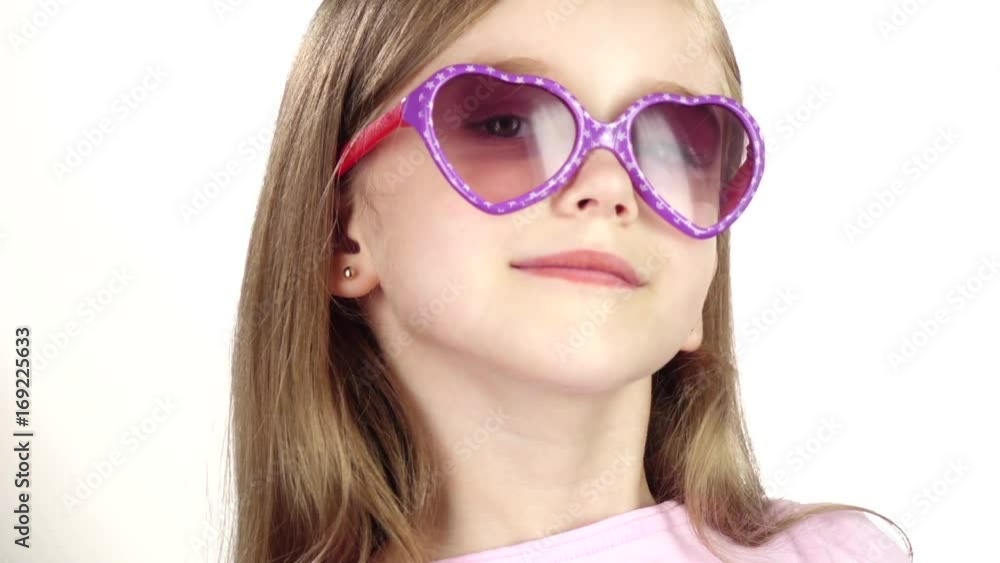 Baby posing for video cameras with glasses. White background. Close up. Slow motion Baby posing for video cameras with glasses. White background. Close up. Slow motion