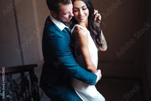Beautiful, young couple posing on camera indoors
