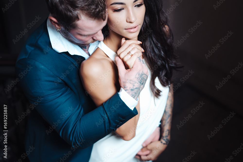 Beautiful, young couple posing on camera indoors
