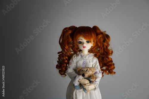 Quadro su tela A doll with lush red hair in an antique dress