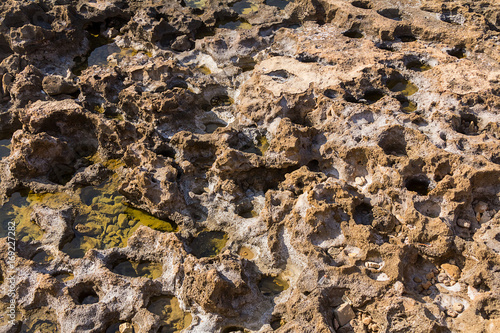 Texture of a weathered stone canvas with craters and natural salt natural background