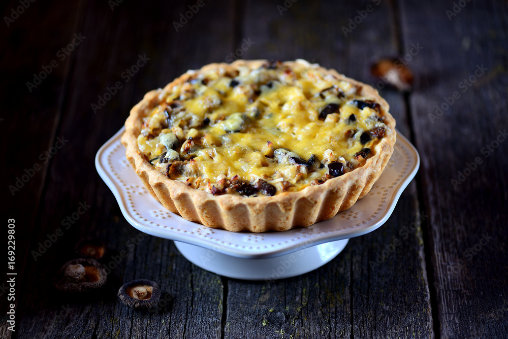 Delicious pie with chicken meat, eggplant, mushrooms, onion and cheese.