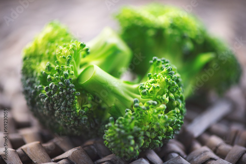 Broccoli. Closeup of fresh green broccoli bunch over wooden background