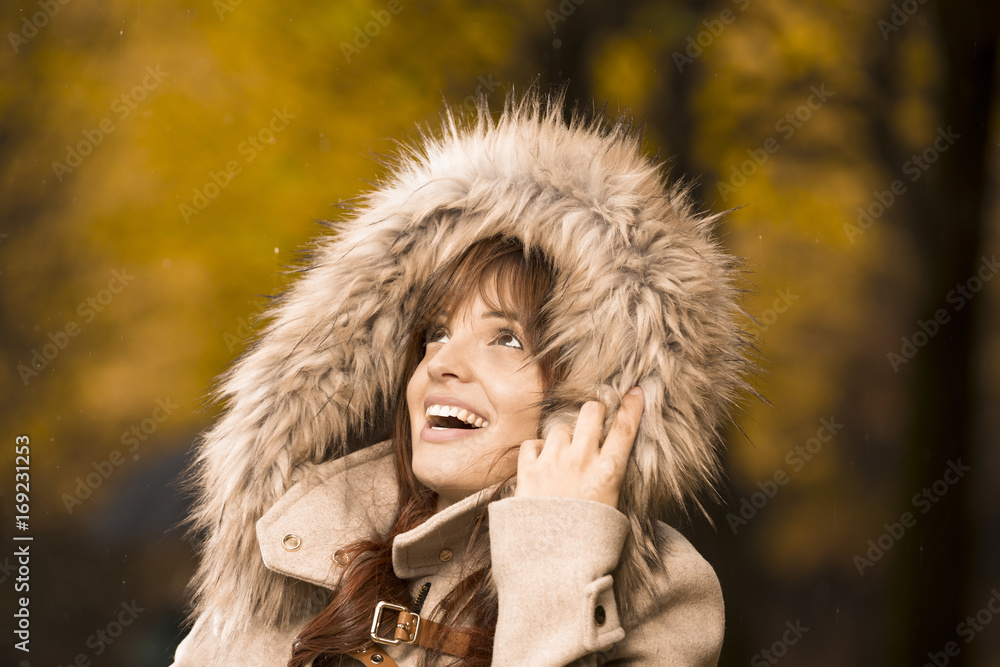 Portrait of a smiling woman in autumn coat enjoying the rain Portrait of a smiling woman in autumn coat enjoying the rain