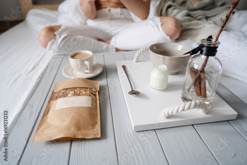 Woman eating cereals in bed