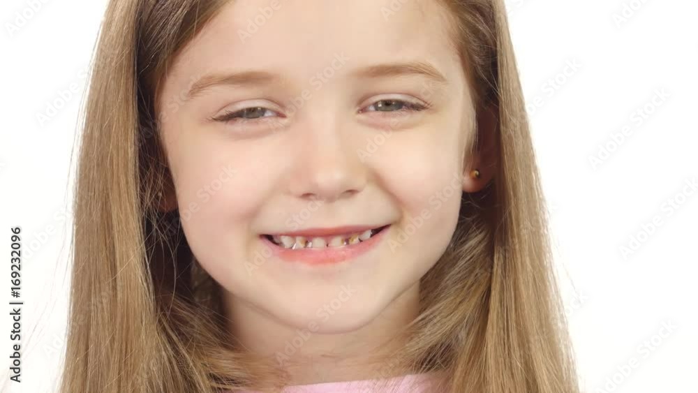 Child genuinely smile at the camera. White background. Close up Child genuinely smile at the camera. White background. Close up