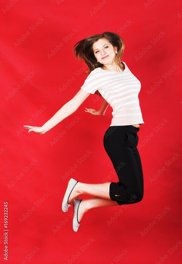 girl jumping of joy over red girl jumping of joy over red